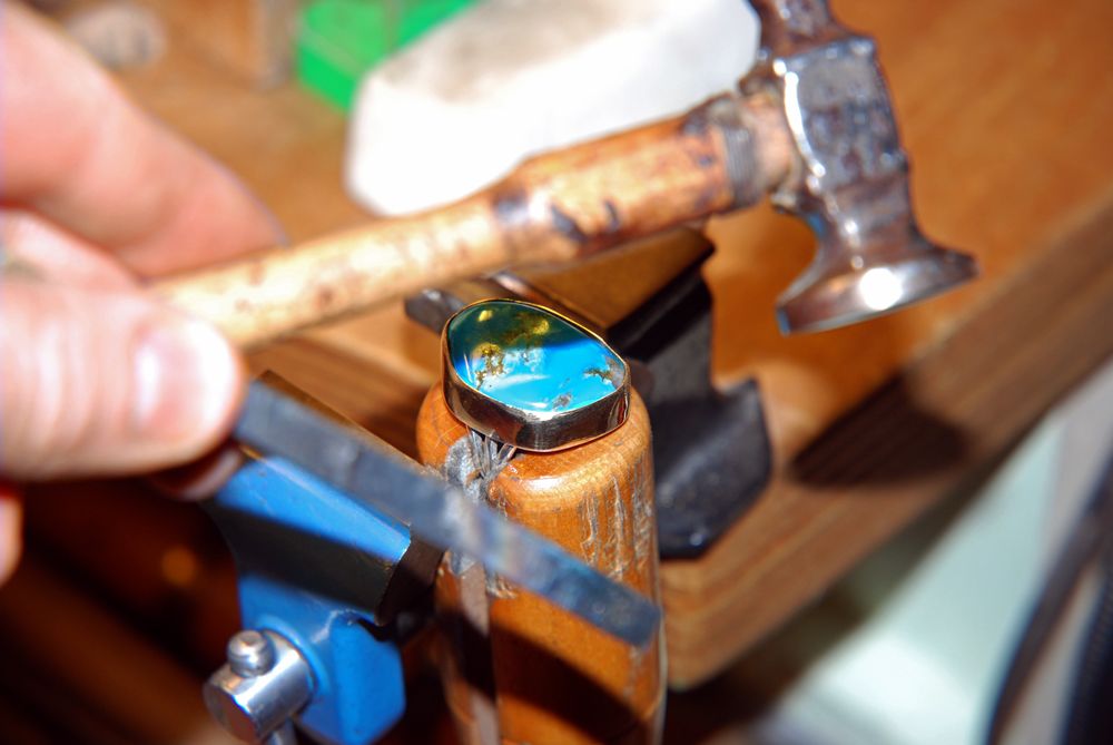 Native Woodland art jeweler creates a turquoise and gold ring in his Amsterdam studio