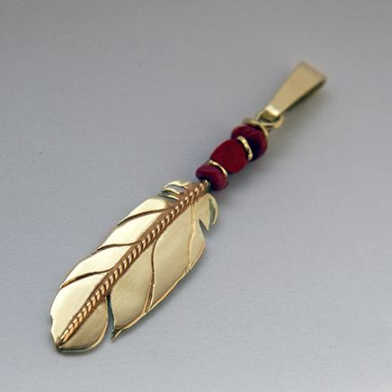 Native American style eagle feather pendant of gold and red coral
