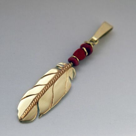 Native American style gold and red coral eagle feather pendant by jeweler Zhaawano